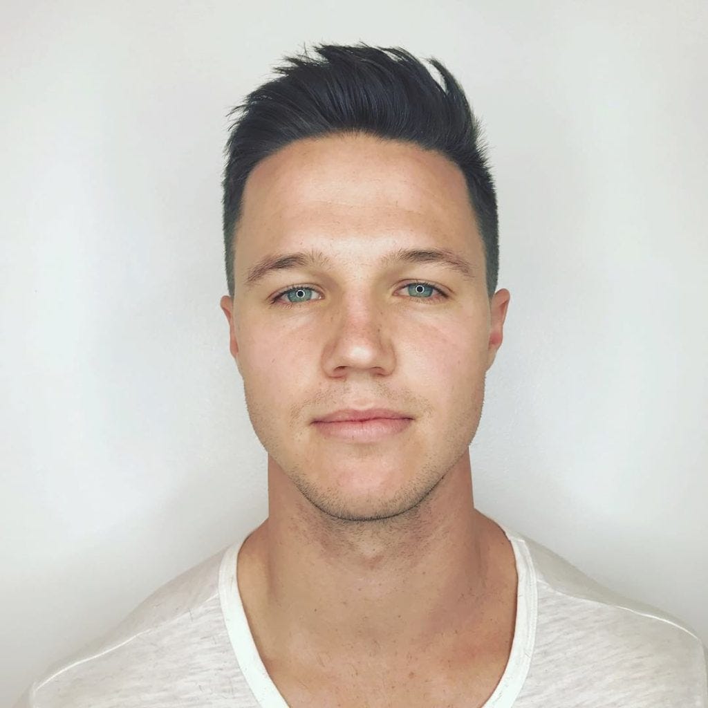 Short Fade Cut With Messy Brushed Up Texture On Black Hair