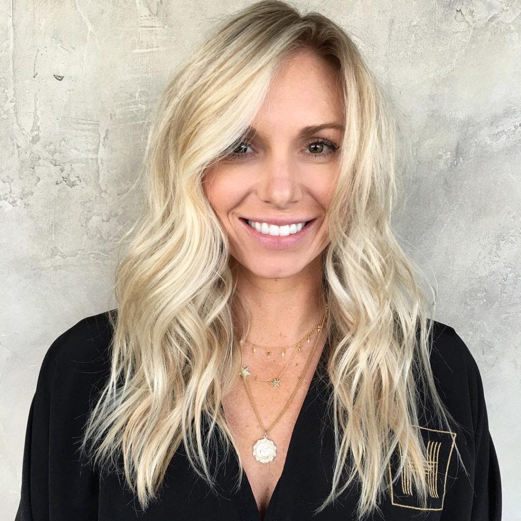 Blonde Layered Cut With Tousled Waves And Subtle Balayage Highlights