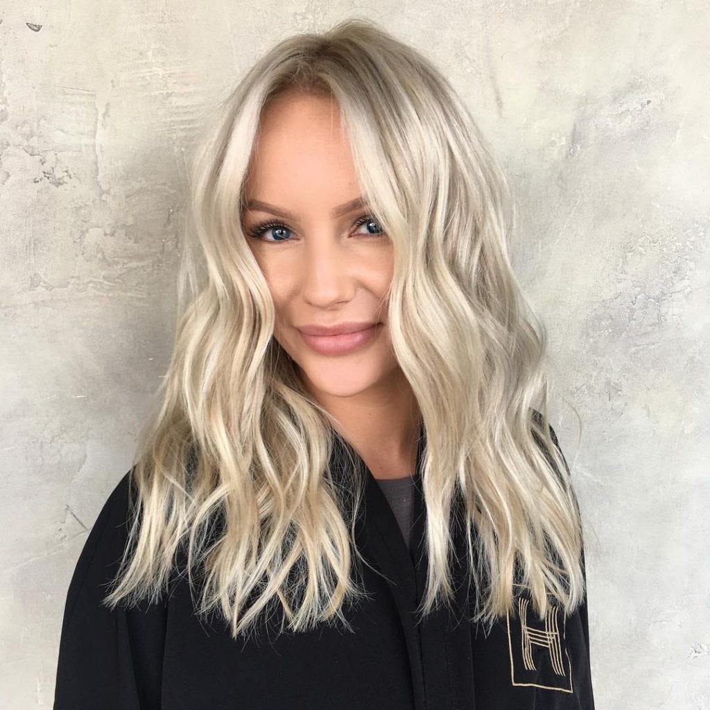 Wavy Blonde Blunt Cut With Textured Ends And Long Parted Bangs