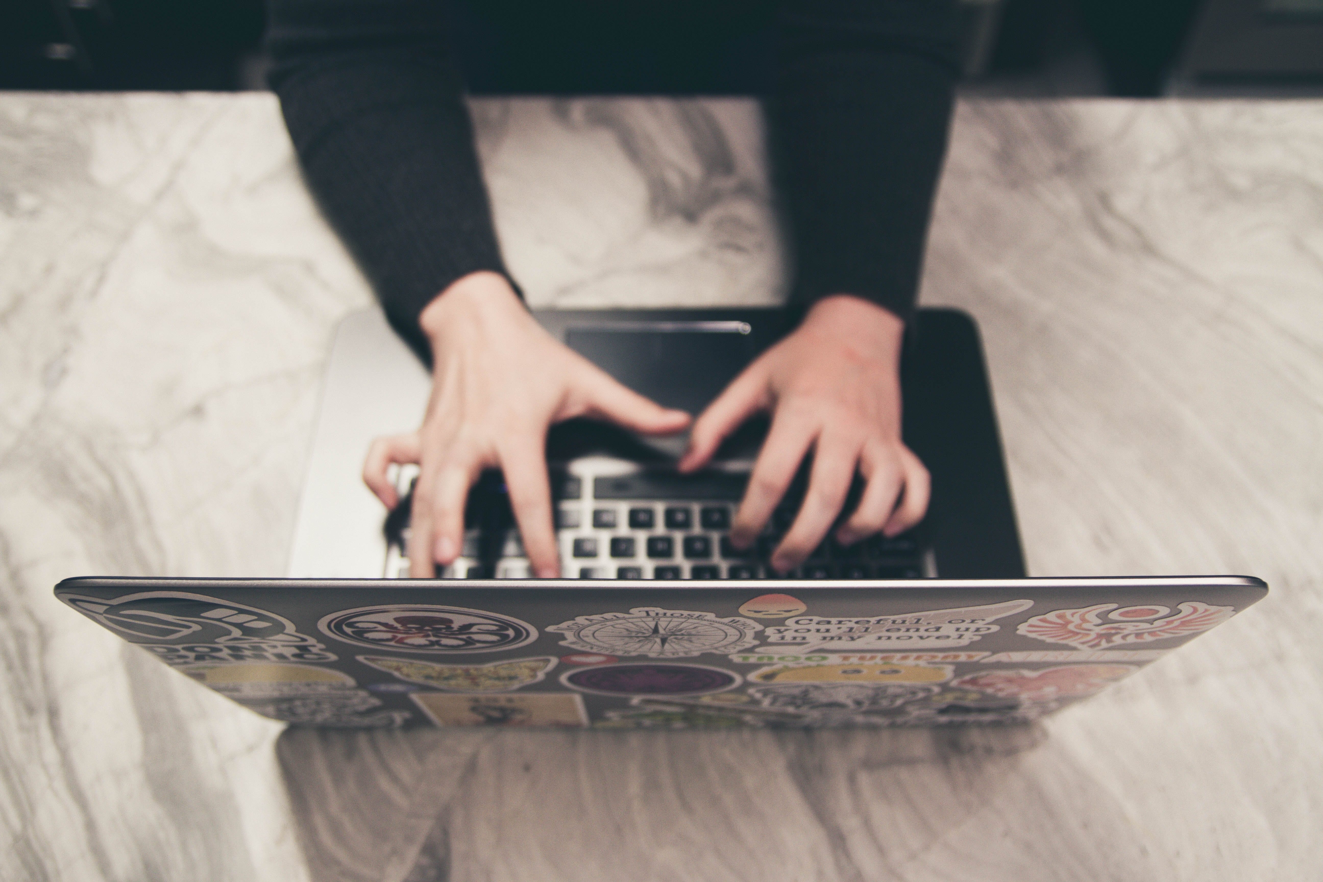 person typing on laptop