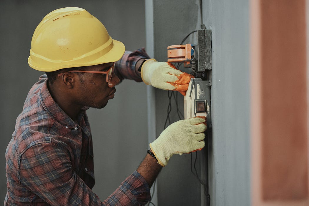 An engineer fixing some cables.
