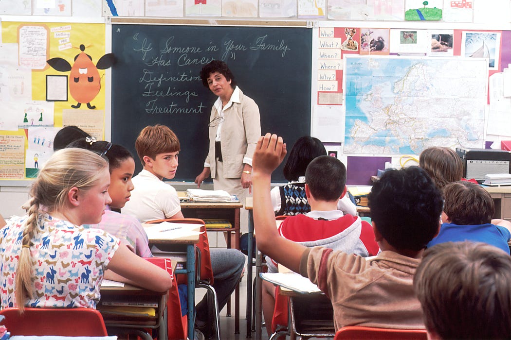 A woman teaching children in a class