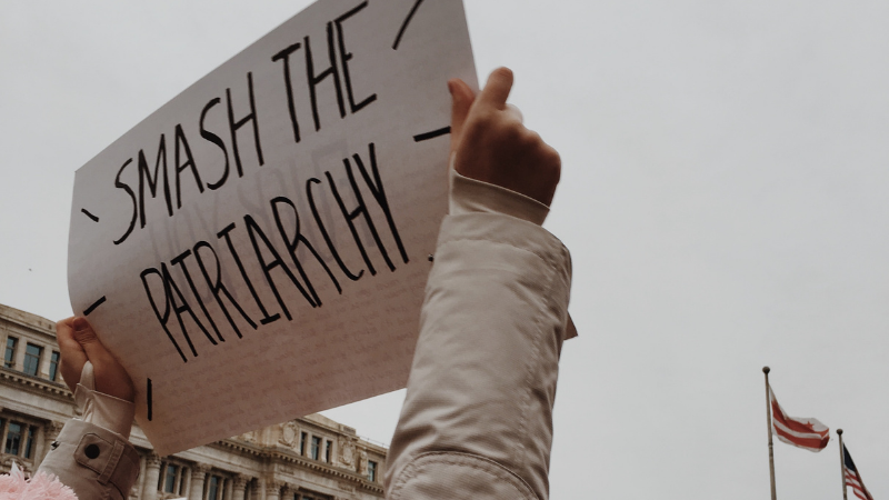 Taken at the DC Women’s March, this photo displays a woman holding a sign that reads “smash the patriarchy”.