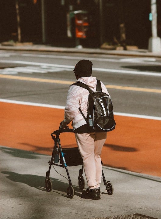 Man with backpack using a wallker