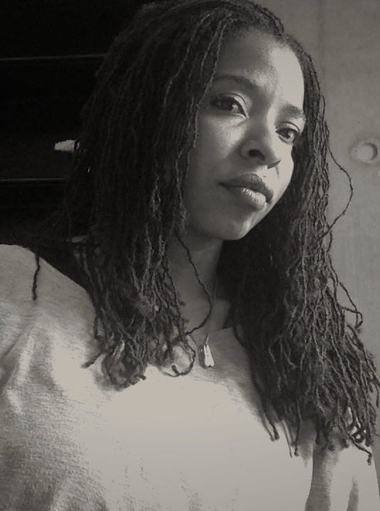 A black & white photo of Desha Dauchan looking slightly to her left