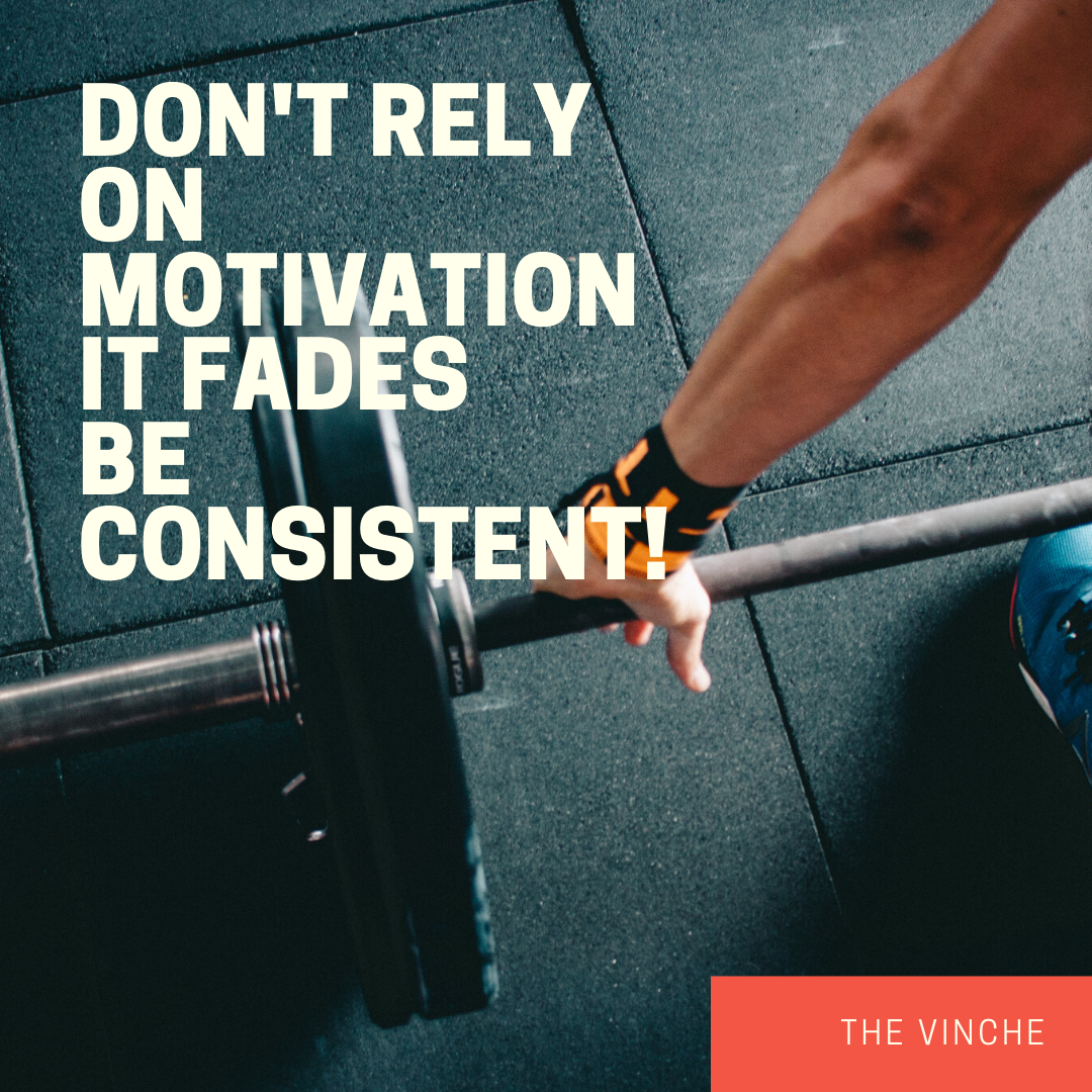 A person sitting at a desk with a laptop, looking determined, symbolizing the shift from motivation to consistency.