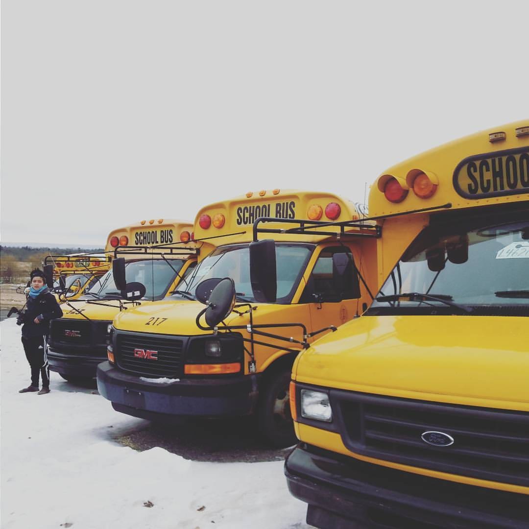 school buses parked in the snow