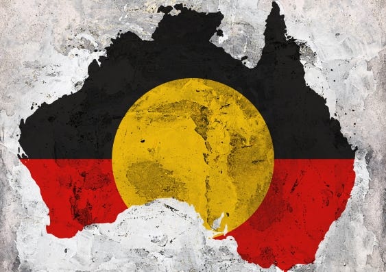A picture of the continent of Australia with the Indigneous flag across it: black and red, with a yellow circle.
