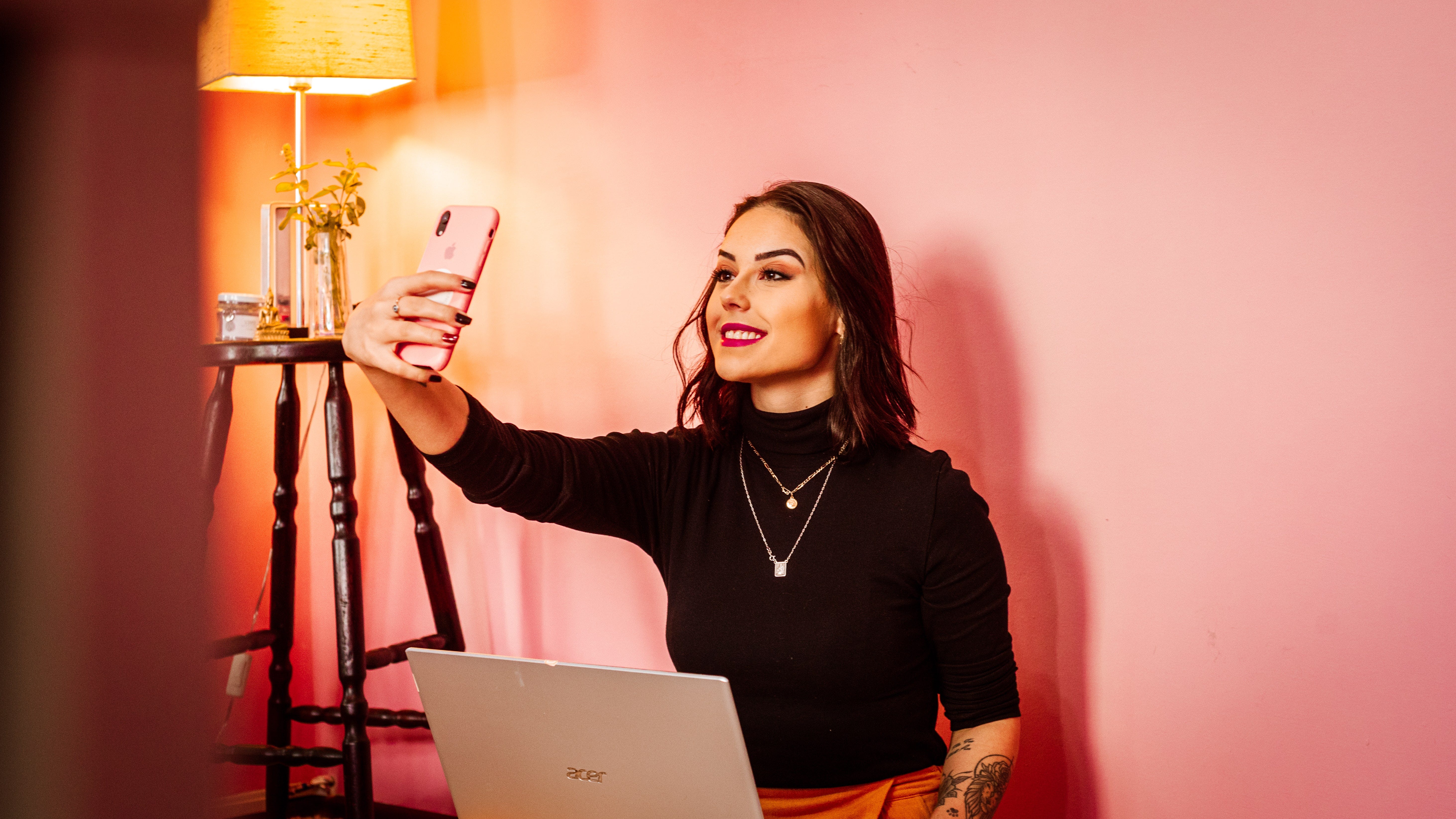 Person with laptop taking selfie.