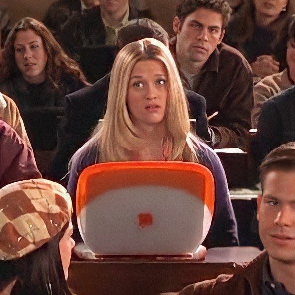 Image of Reese Witherspoon from Legally Blonde sitting in a classroom.