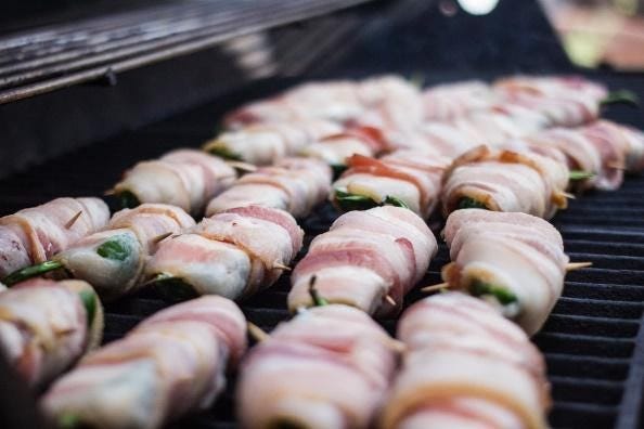 best keto diet snacks bacon wrapped jalapeños cooking on a grill