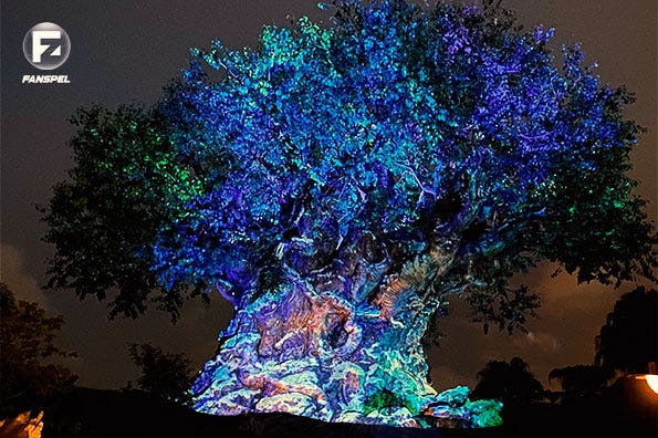 An old tree which glows in rainbow colours with artificial light