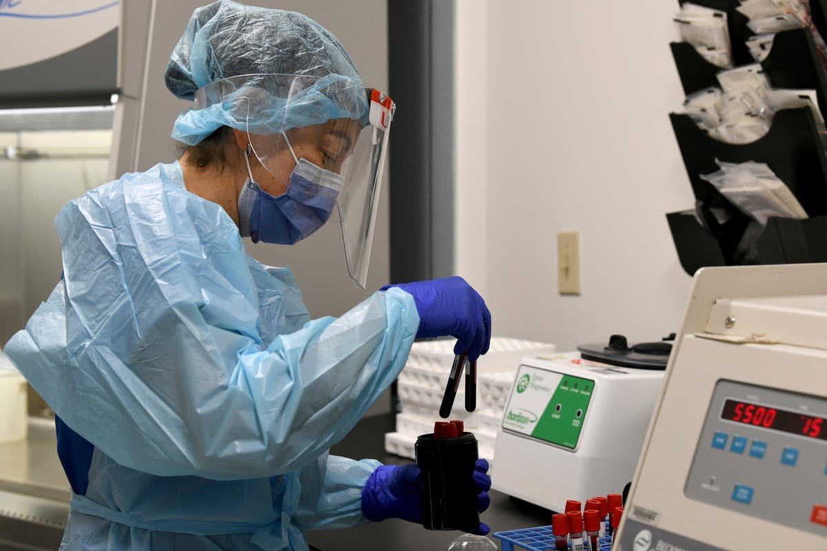 The lab technician Sendy Puerto processes blood samples from Moderna's clinical trial in Miami.