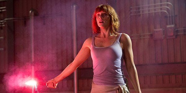 Claire Dearing, played by Bryce Dallas Howard, holds a flare at the end of Jurassic World.