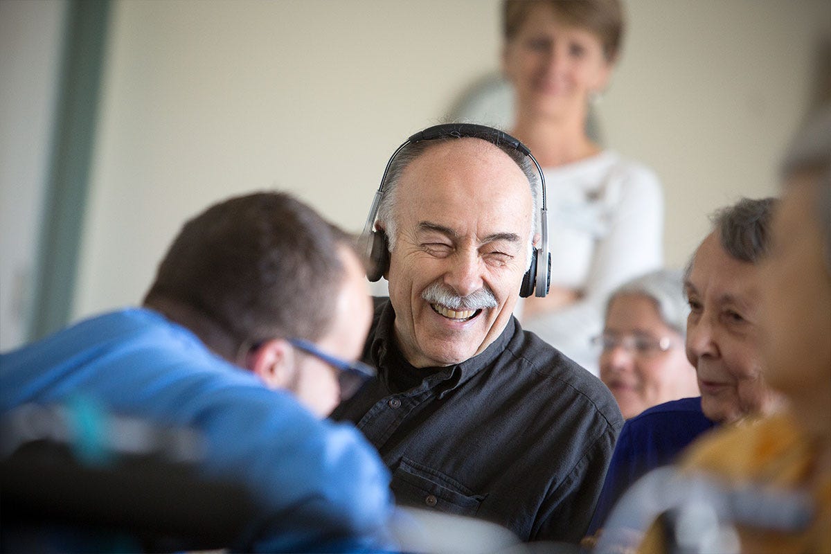 Senior citizens listening to Eversound headphones.