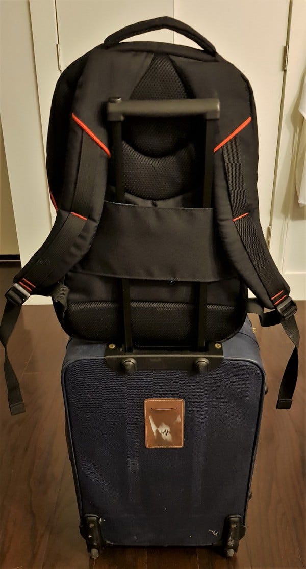 suitcase with backpack attached