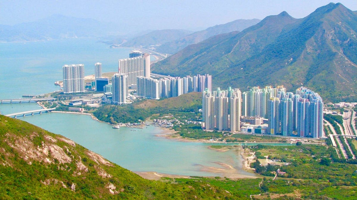 A Complete Guide To Tung Chung. Tall structures, green mountains… by