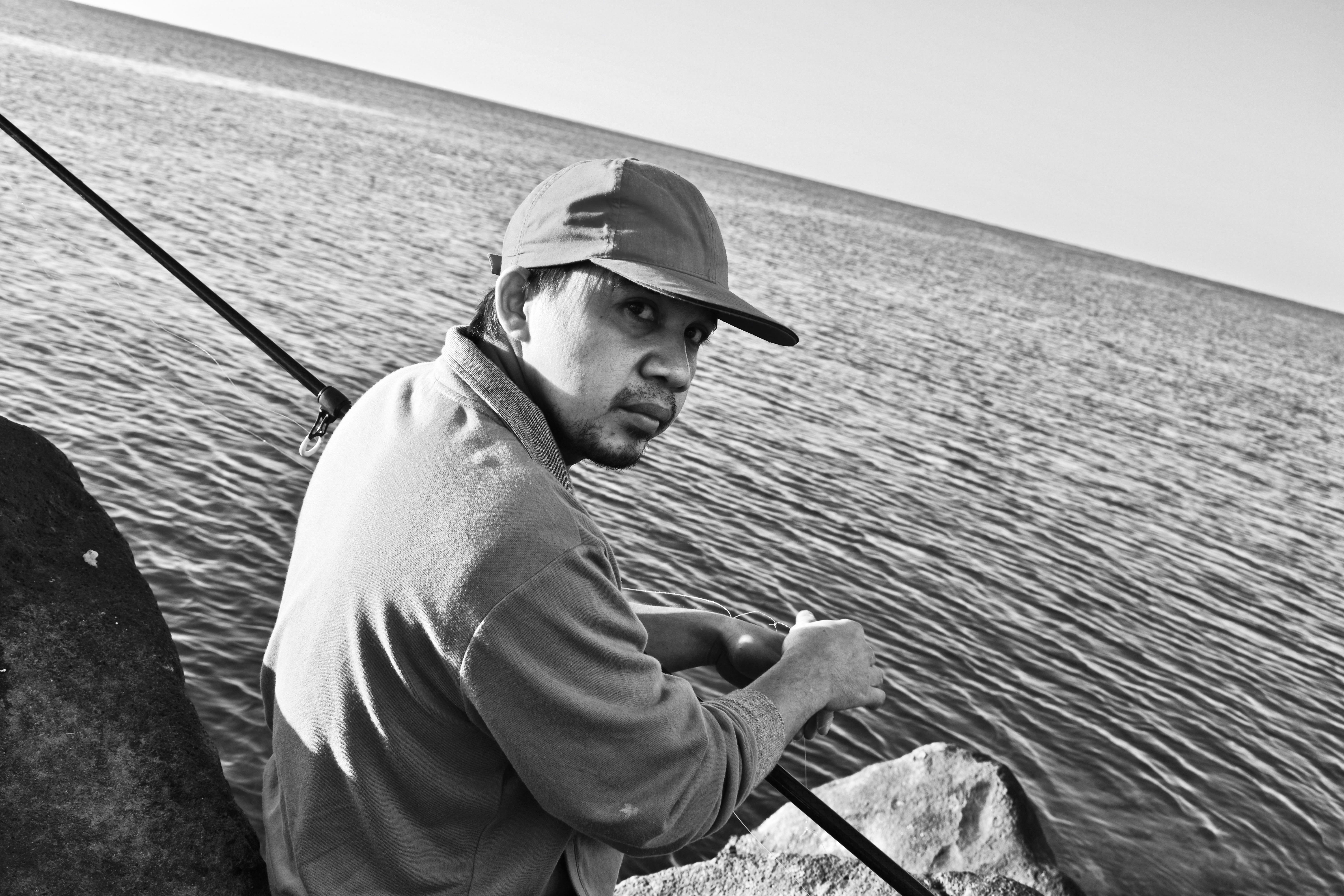 A father catching a fish in the bay