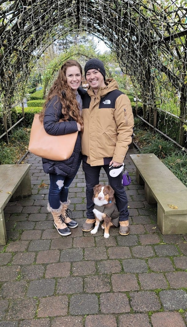 couple and a dog in greenhouse