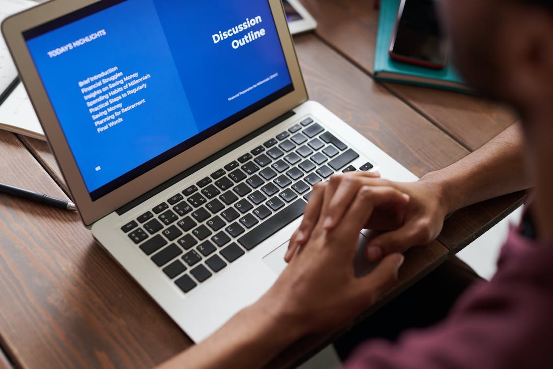 Image of someone looking at a laptop