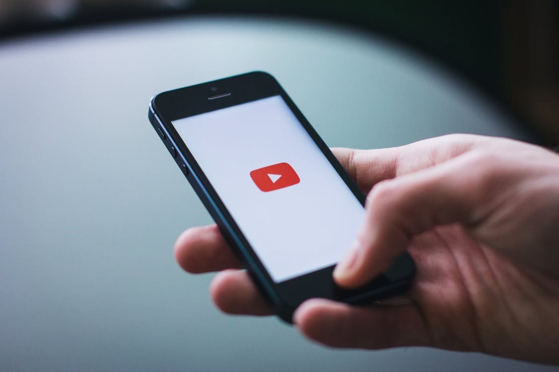 Image of a phone opening the YouTube app