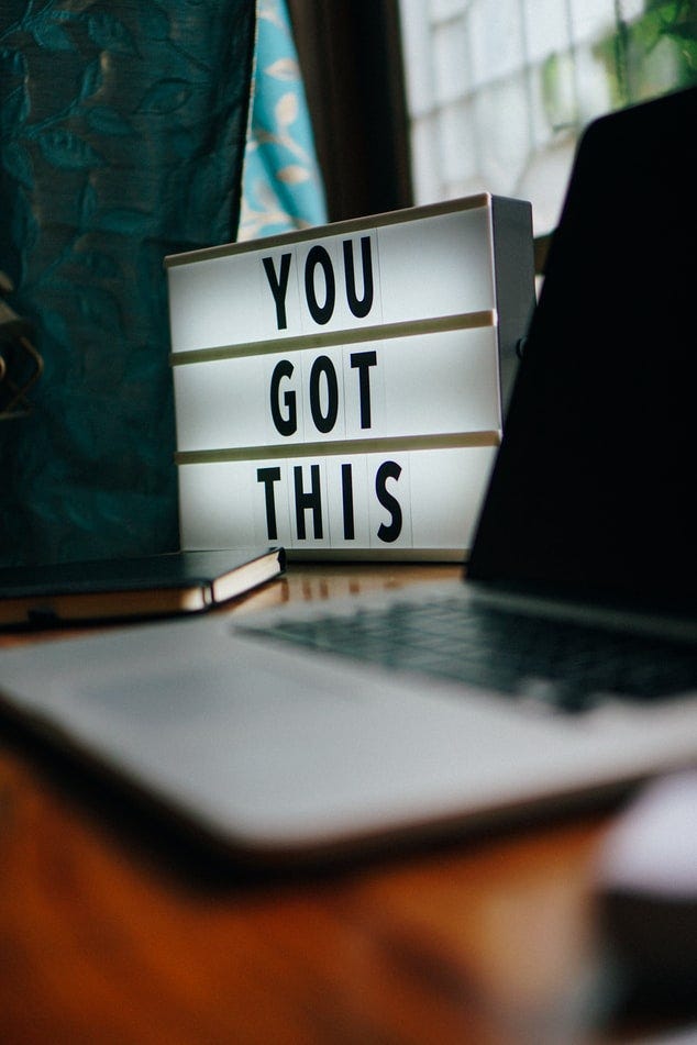Laptop with “You Got This” sign for inspiration