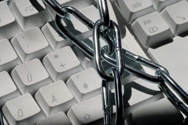 Image shows a keyboard wrapped in metal chains