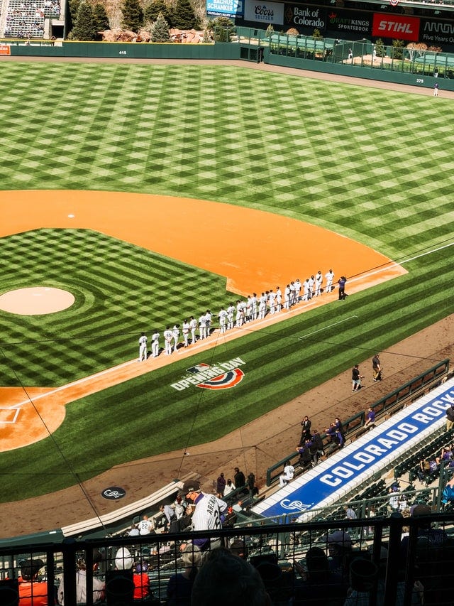 Baseball players lined up during the national anthem performance