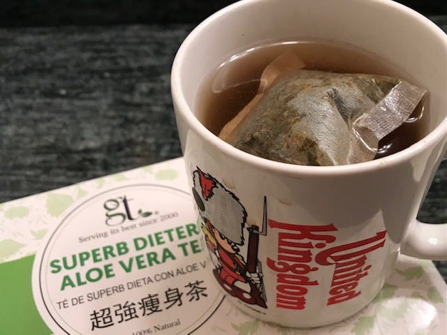mug of hot tea on a box of tea