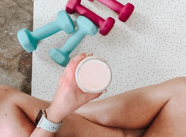 A woman holds a health shake.