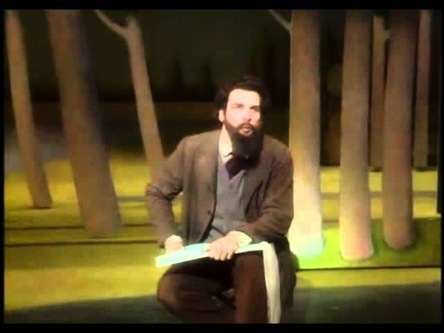 In scene from the musical “Sunday in the Park with George,” actor Mandy Patimkin, as Georges Seurat, looks up from a blank page as he sits in front of trees that will ultimately appear in Seurat’s painting “A Sunday Afternoon on the Island of La Grande Jatte.”