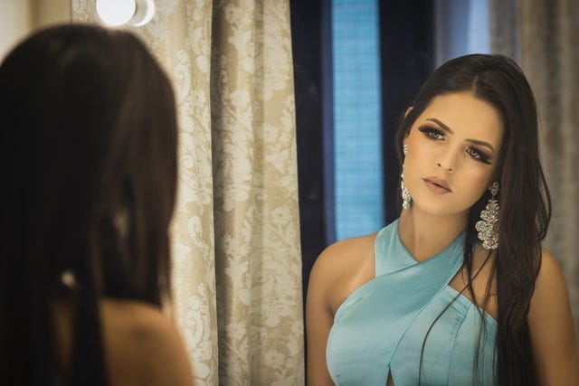 Dark haired woman in mirror