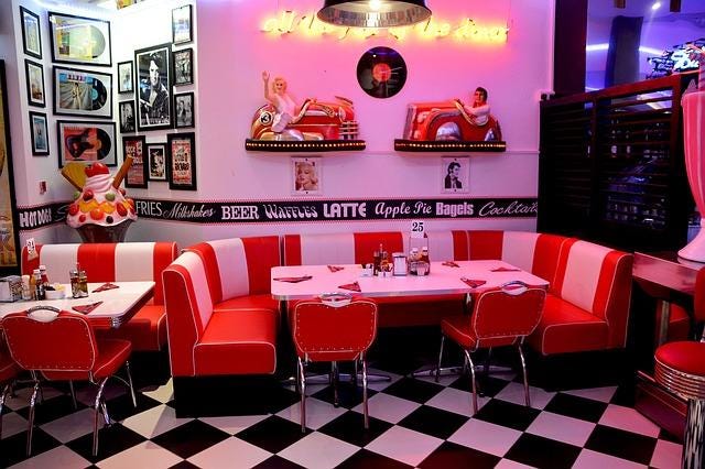 A diner setting with a vinyl round booth.
