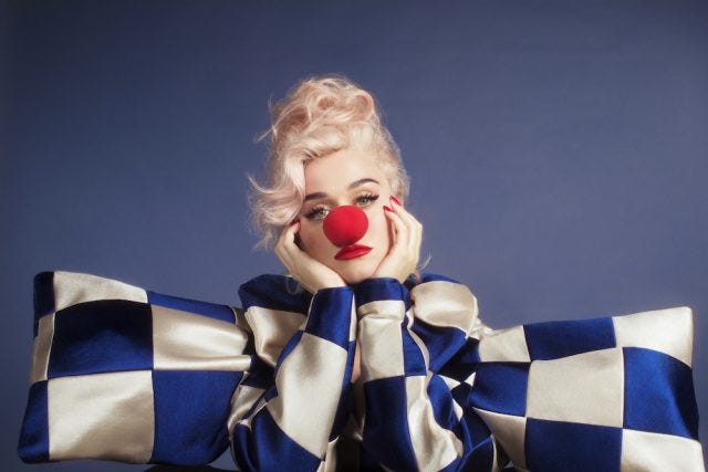 Katy Perry ‘Smile’ album cover with a checkered blue-and-white shirt and a clown nose.