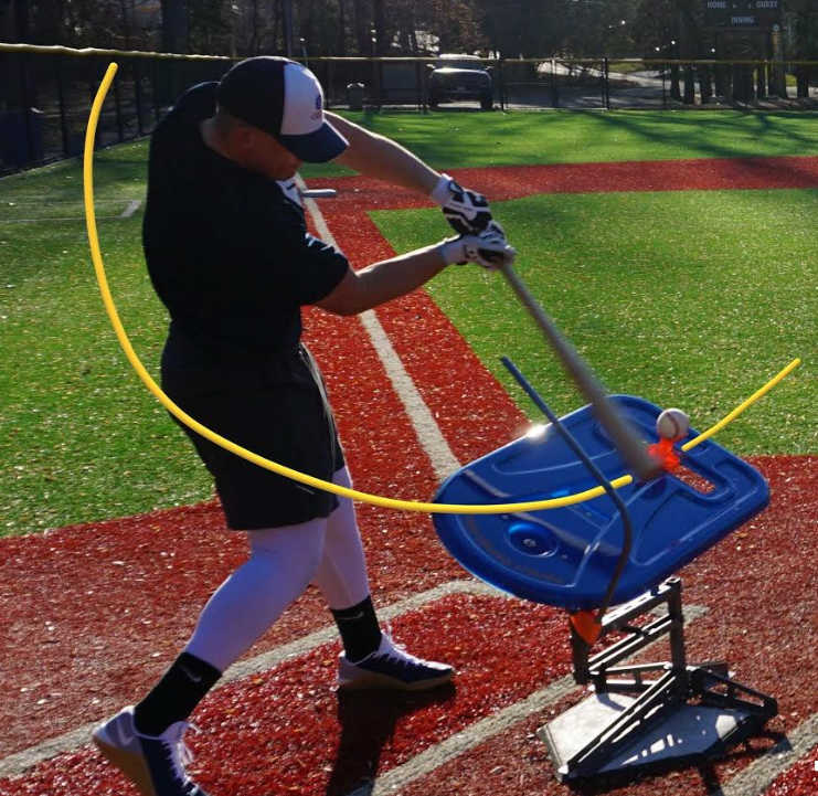 baseball player swinging bat and hitting ball off swing path trainer