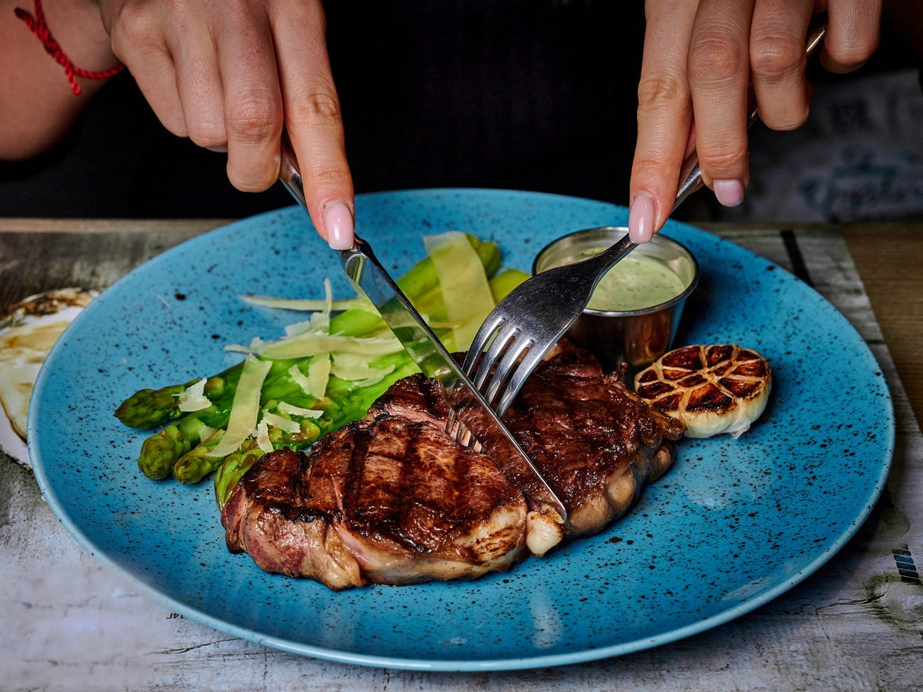 An individual cutting into meat.