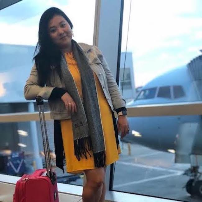 Karen loves to fly around the world as evidenced by this picture of her at the airport.
