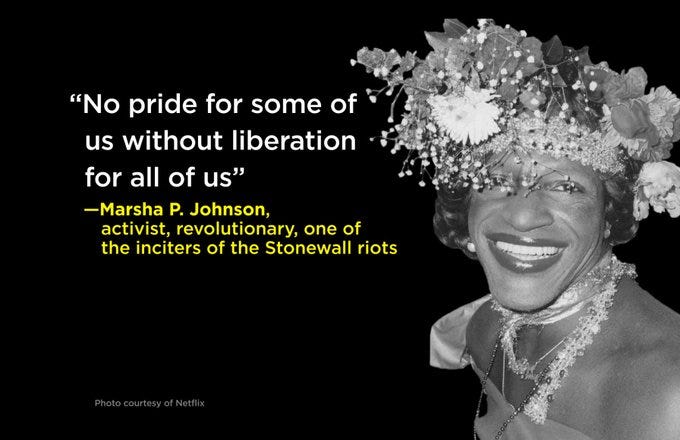 A black and white photograph of Marsha P. Johnson, smiling at the camera and wearing a floral crown. Text superimposed on the image reads, “‘No pride for some of us without liberation for all of us’ — Marsha P. Johnson, activist, revolutionary, one of the inciters of the Stonewall riots”