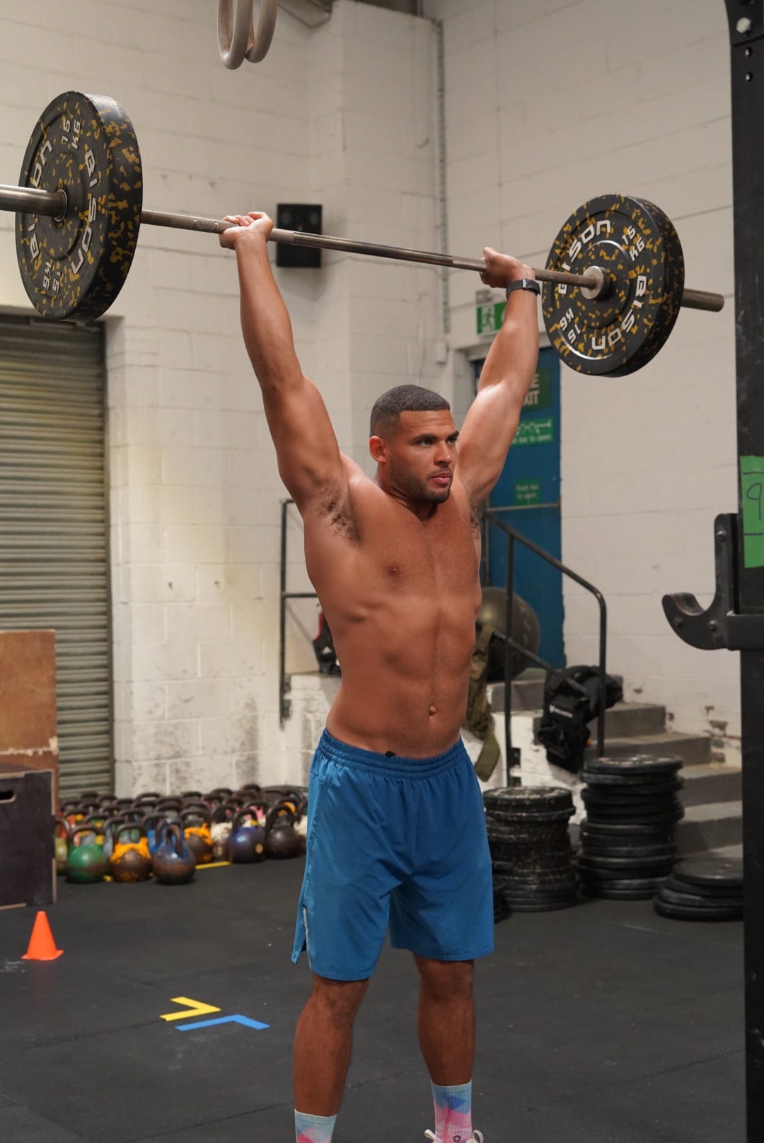 Zack George at the top of a shoulder press.