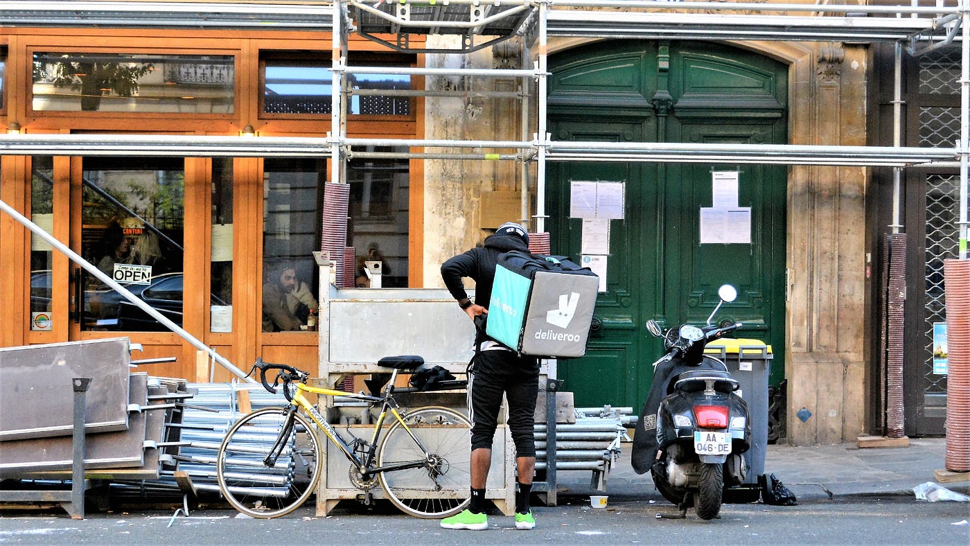 Deliveroo rider stopping outside a restaurant
