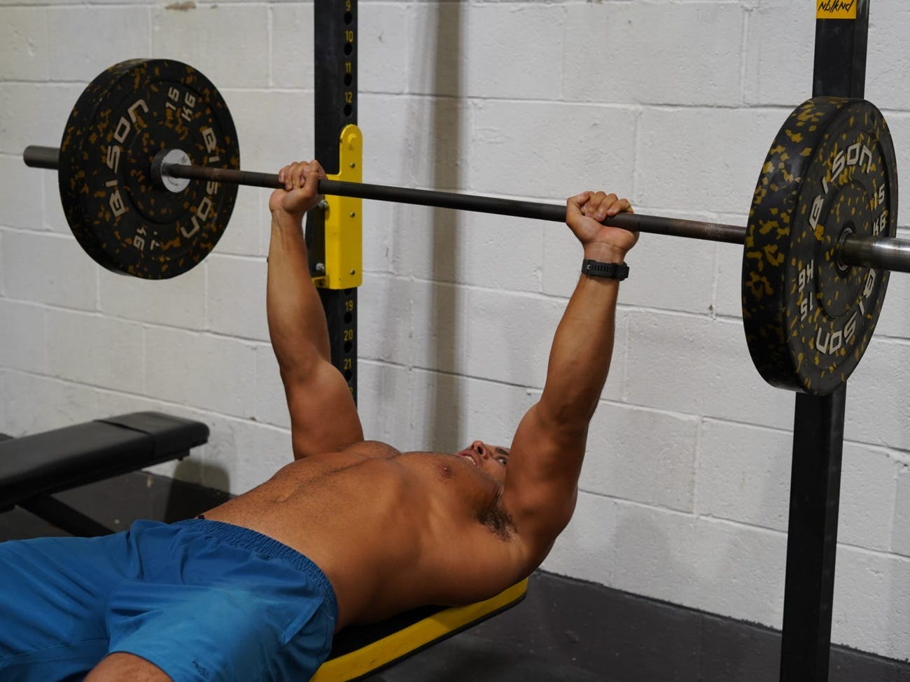 Zack George at the top of a barbell bench press.