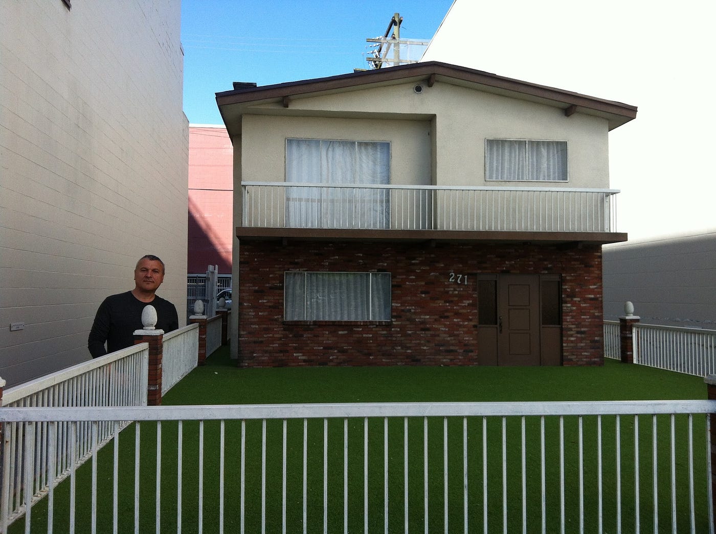 a man standing in front of a house