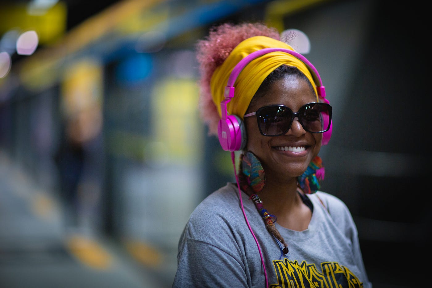 Lady wearing bright pink headphones