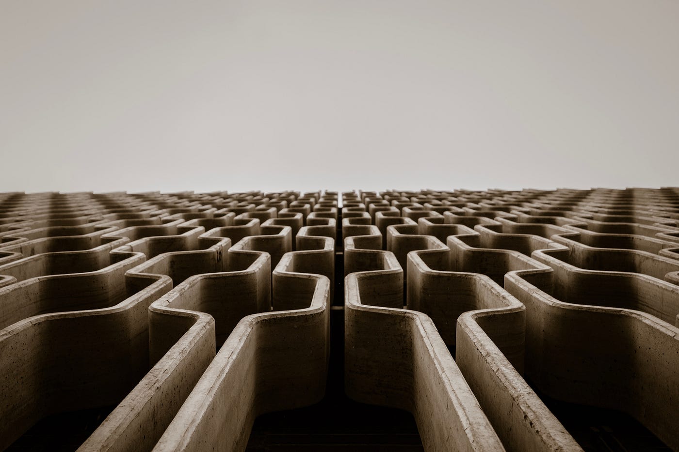 A sepia image of a maze, seen obliquely.