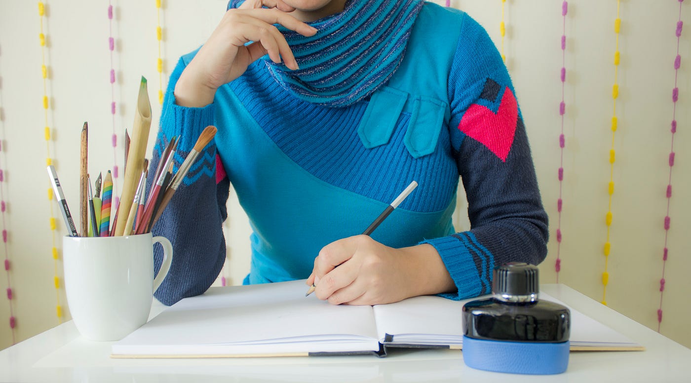 Person taking notes or drawing on a notebook