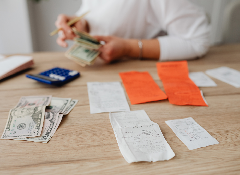 Woman looking at receipts and counting money.