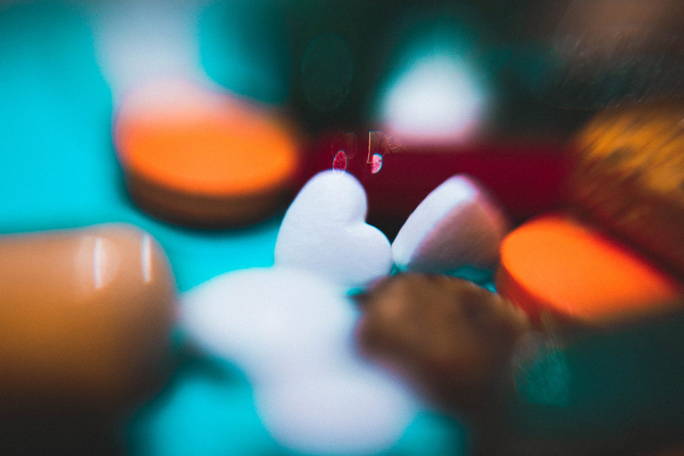 A buch of medicines or candy of various shaped and colors. The image is blurred except for the center.