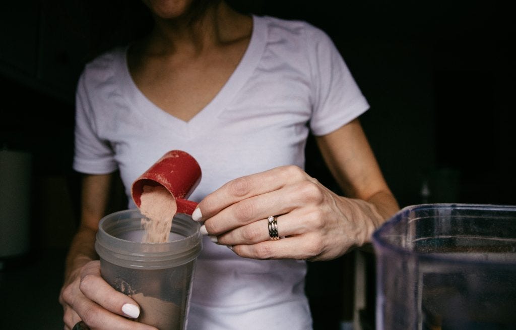 Person preparing a protein shake