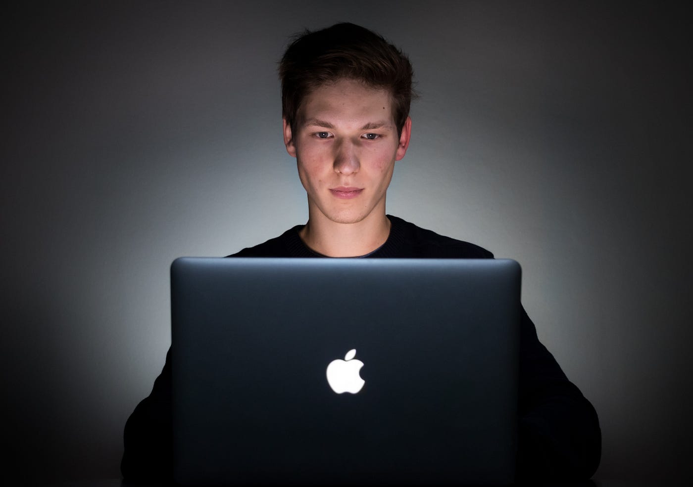 A guy sitting at his Mac book
