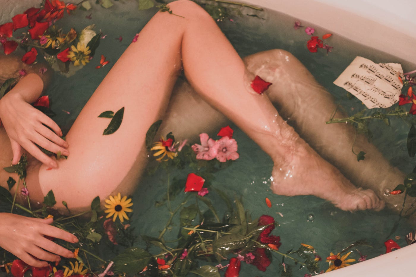 women in a beautiful bath of flowers